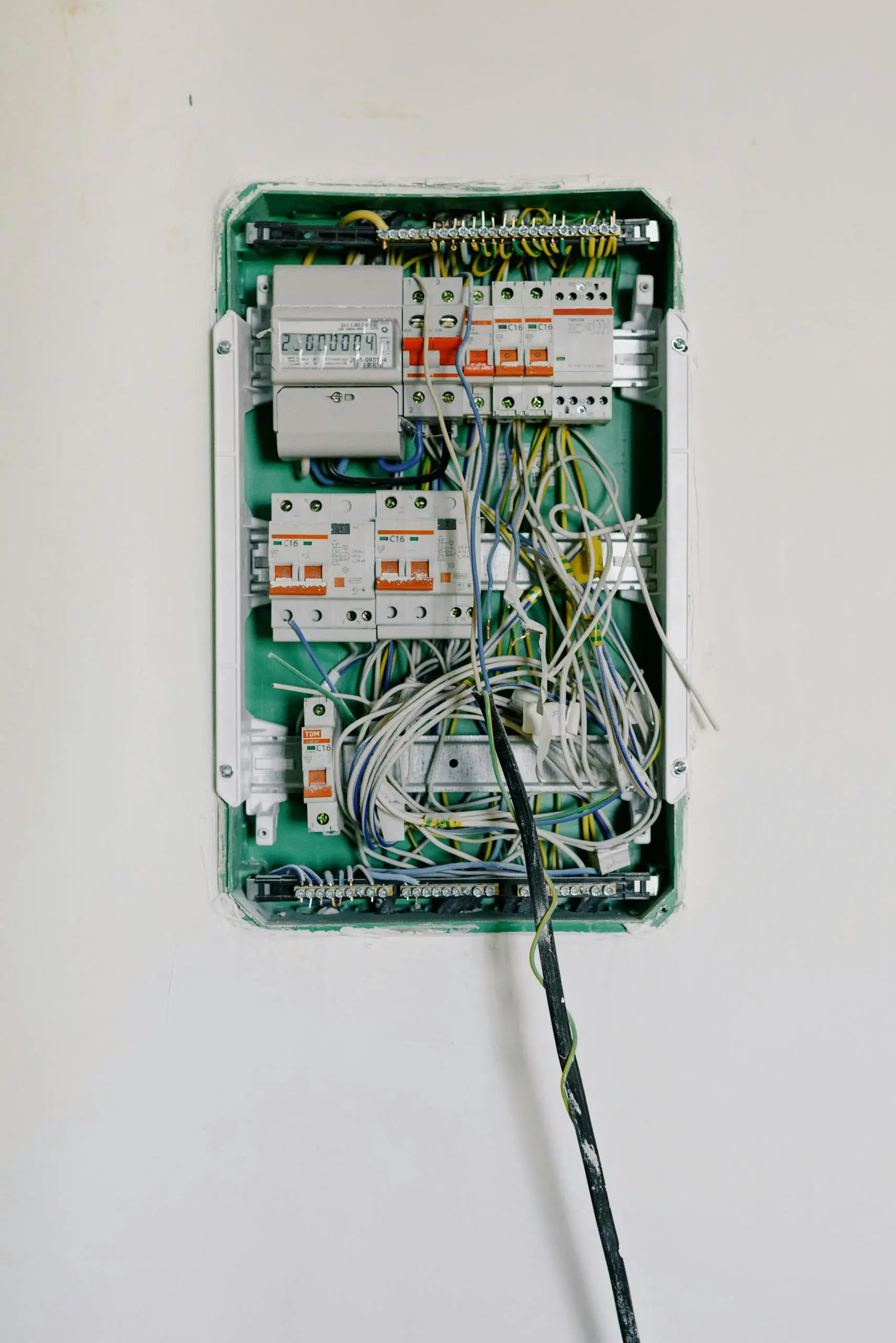 Open electrical panel with circuit breakers and wiring