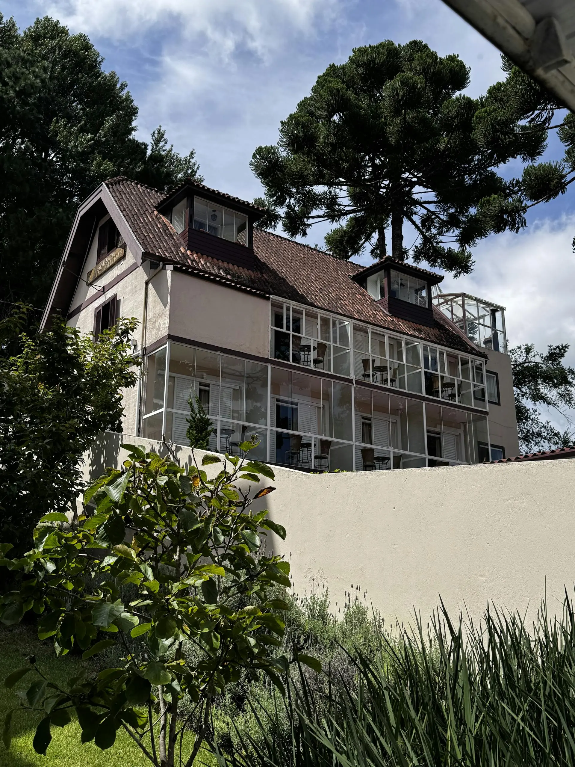 European-style house with glass windows in a lush garden