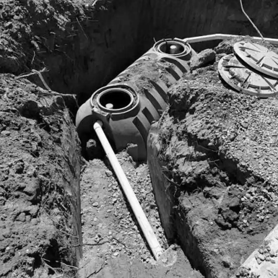 New septic tank placed in trench with inlet pipe connected