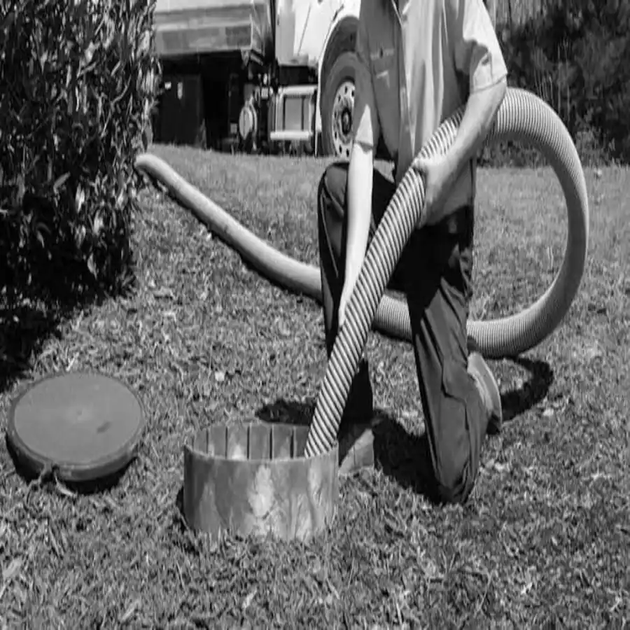 How to locate your septic tank - technician pulling the pump hose toward the tank