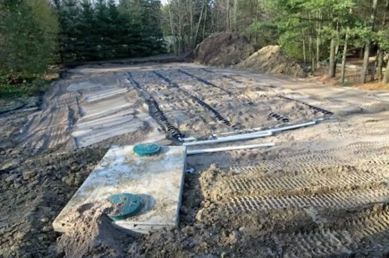 Septic drain field trenches being installed in a yard