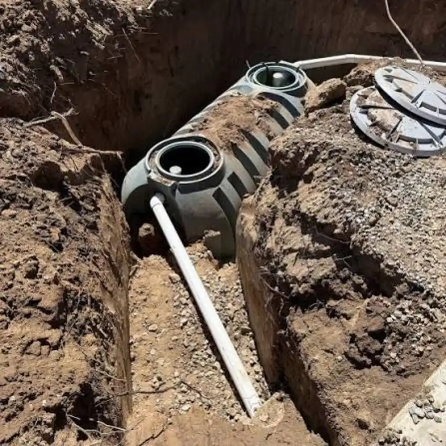 Septic tank being lowered into an installation trench